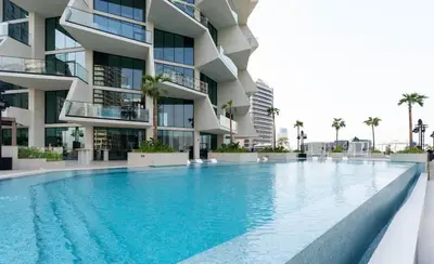 a swimming pool in front of a building at Exclusive 1BR W Private Pool Binghatti Royale in Dubai