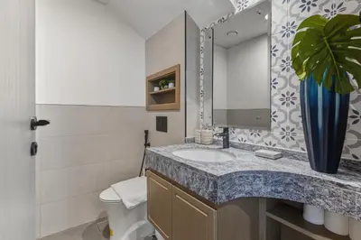 a bathroom with a sink and a toilet and a mirror at Five-Bedroom plus maid's room villa with Multiple En-Suites Sunset Roof Terraces & Exceptional Space in Dubai
