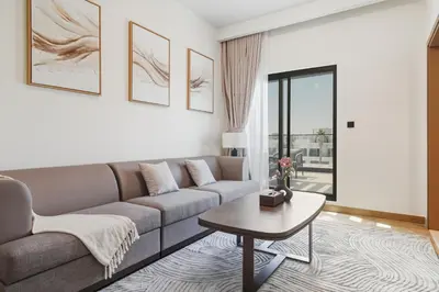 a living room with a couch and a table at Five-Bedroom plus maid's room villa with Multiple En-Suites Sunset Roof Terraces & Exceptional Space in Dubai