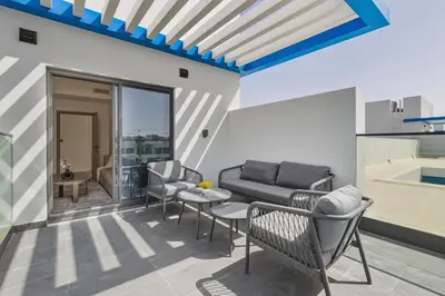 a living room with a couch and chairs and a table at Five-Bedroom plus maid's room villa with Multiple En-Suites Sunset Roof Terraces & Exceptional Space in Dubai