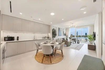 a kitchen and living room with a table and chairs at Beachfront stay at Beach Mansion with Private Beach in Dubai