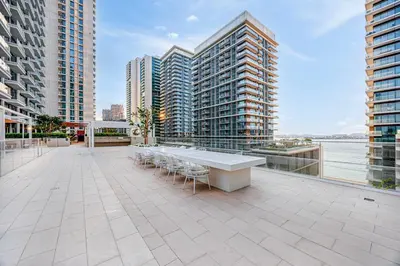 a balcony with a table and chairs and buildings at Beachfront stay at Beach Mansion with Private Beach in Dubai
