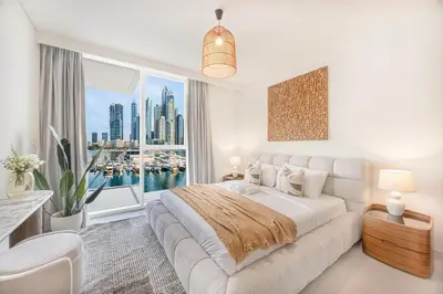a bedroom with a large bed and a large window at Beachfront stay at Beach Mansion with Private Beach in Dubai