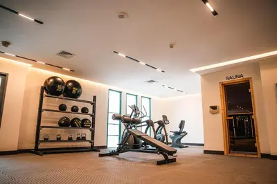 a fitness room with a gym with a treadmill at 1BDR Centrally Located Near Metro in Dubai