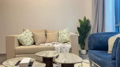 a living room with a couch and two tables at 1BDR Centrally Located Near Metro in Dubai