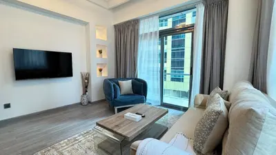 a living room with a couch and a tv at 1BDR Centrally Located Fully Equipped Kitchen in Dubai