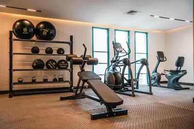 a gym with several exercise bikes and exercise balls at 1BDR Centrally Located Fully Equipped Kitchen in Dubai
