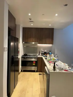 a kitchen with a stainless steel refrigerator and a counter at La Cote, free Beach access in Dubai