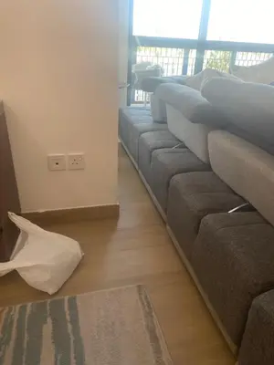 a row of couches in a living room at La Cote, free Beach access in Dubai