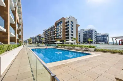 a swimming pool in the middle of a building at TRPS - Azizi Riviera 5, Al Meydan - Modern Luxury 1BR, Minutes to Burj Khalifa in Dubai