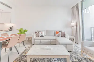a living room with a couch and a table at HAVN - 1 bed in Luma Parks, JVC in Dubai
