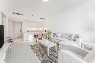 a living room with a couch and a table at HAVN - 1 bed in Luma Parks, JVC in Dubai