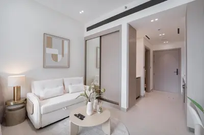 a living room with a white couch and a table at Boutique Studio at Binghatti Aurora by Czechin in Dubai