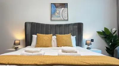 a bedroom with a large bed with yellow pillows at Studio Centrally Located Near to Metro in Dubai