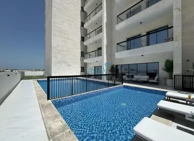 a swimming pool in front of a building at Modern 1BHK Equiti Arcade- Al Furjan -Near Metro in Dubai