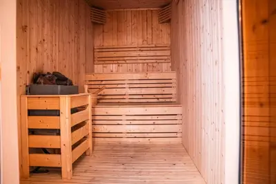 a sauna with wooden walls and a wooden table at 1 Bedroom Centrally located near the Metro in Dubai