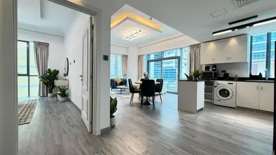 a living room with a kitchen and a dining room at 1 Bedroom Centrally located near the Metro in Dubai