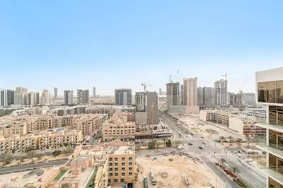an aerial view of a city with tall buildings at VayK - Bright Modern Apartment in JVC - 1BR Gem in Dubai