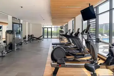 a gym with treadmills and cardio machines at Bright 1BR in Executive Residences 2, Dubai Hills in Dubai