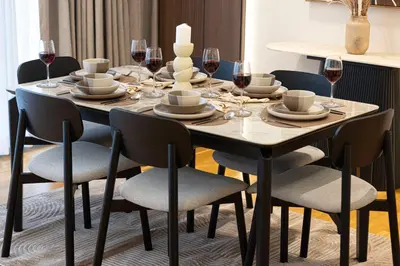 a dining room table with chairs and wine glasses at Island Living in Bluewaters, Close to JBR Beach in Dubai