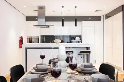 a kitchen with a table with glasses of wine at Island Living in Bluewaters, Close to JBR Beach in Dubai