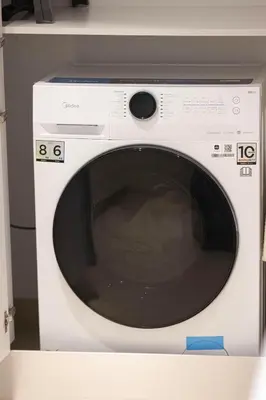 a white washing machine sitting on a shelf at Island Living in Bluewaters, Close to JBR Beach in Dubai