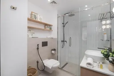 a bathroom with a toilet and a glass shower at Modern 1BHK Jewels Tower, Dubai Marina by Czechin in Dubai