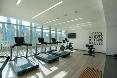 a gym with a bunch of exercise equipment in a room at VayK - Elegant 2BR at Emaar Beachfront with Beach Access in Dubai