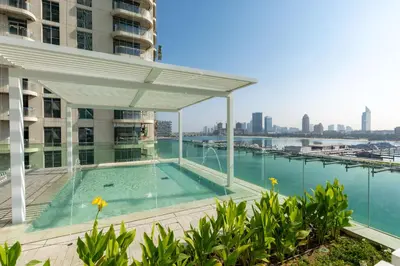 a swimming pool on the roof of a building at VayK - Elegant 2BR at Emaar Beachfront with Beach Access in Dubai