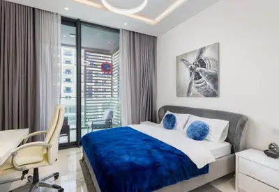 a bedroom with a bed and a desk and a window at VayK - Extra-Large 2BR in Dubai Hills Close to Mall & Park in Dubai