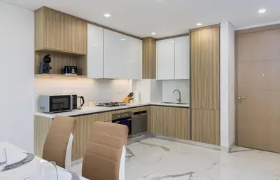 a kitchen with white cabinets and white appliances at VayK - Extra-Large 2BR in Dubai Hills Close to Mall & Park in Dubai