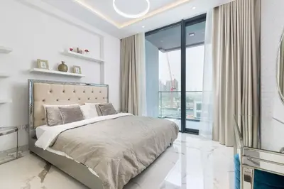 a bedroom with a bed and a large window at VayK - Extra-Large 2BR in Dubai Hills Close to Mall & Park in Dubai