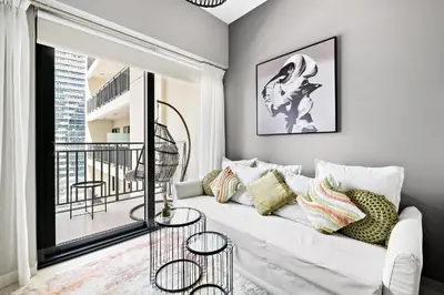 a living room with a white couch and a balcony at VayK - Newly Launched 1BR in Business Bay in Dubai