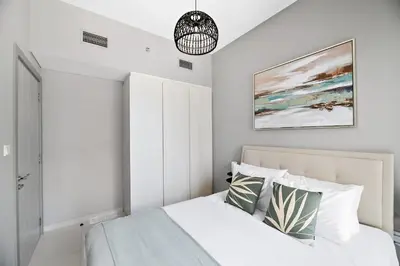 a bedroom with a bed and a painting on the wall at VayK - Newly Launched 1BR in Business Bay in Dubai