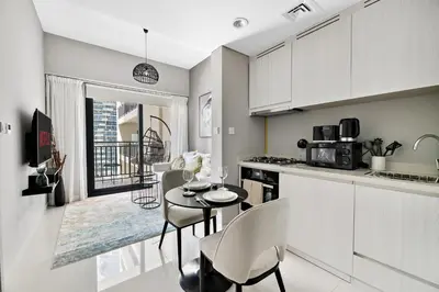 a kitchen with a table and chairs in a kitchen at VayK - Newly Launched 1BR in Business Bay in Dubai