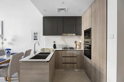 a kitchen with a sink and a stove top oven at VayK - Contemporary 1BR in a New JVC Community in Dubai