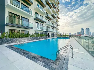 a swimming pool in front of a building at VayK - Chic 1BR Urban Getaway in Dubai