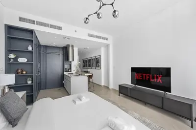 a bedroom with a bed and a desk in it at VayK - Ideal Studio in Sobha Hartland in Dubai