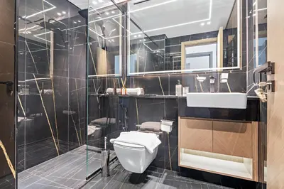 a bathroom with a toilet and a sink and a shower at VayK - Comfortable 1BR in JVC in Dubai