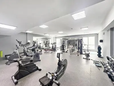 a gym with several treadmills and exercise bikes at VayK - Modern 1BR Near Metro in Dubai Marina in Dubai