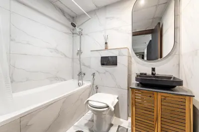 a bathroom with a sink and a toilet and a mirror at VayK - Modern 1BR Near Metro in Dubai Marina in Dubai