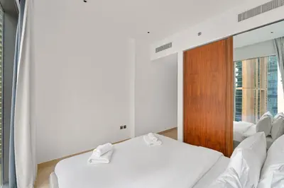 two beds in a room with a mirror at VayK - Lovely 1BR in Central Dubai Marina in Dubai