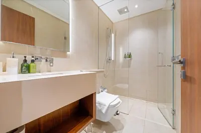 a bathroom with a shower and a toilet and a sink at VayK - Lovely 1BR in Central Dubai Marina in Dubai