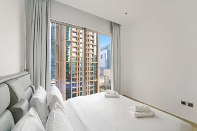 a bedroom with a bed and a large window at VayK - Lovely 1BR in Central Dubai Marina in Dubai
