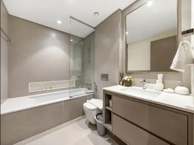a bathroom with a toilet and a sink and a mirror at Luxury Apartments in Downtown Near Dubai Mall and Burj Khalifa View in Dubai