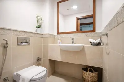 a bathroom with a sink and a toilet and a mirror at Luxury Apartments in Downtown Near Dubai Mall and Burj Khalifa View in Dubai