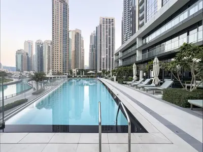 a large swimming pool in a city with tall buildings at Luxury Apartments in Downtown Near Dubai Mall and Burj Khalifa View in Dubai