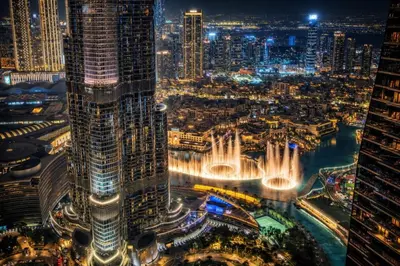 a view of a city at night with a fountain at Luxury Apartments in Downtown Near Dubai Mall and Burj Khalifa View in Dubai