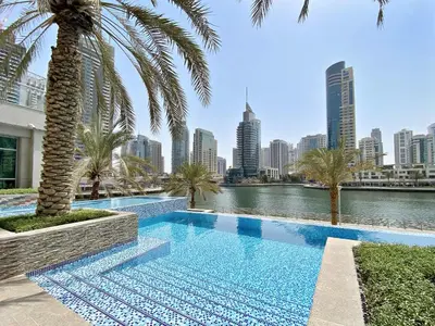 a swimming pool with a city skyline in the background at VayK - Inviting 1BR in Dubai Marina with Stunning Views in Dubai