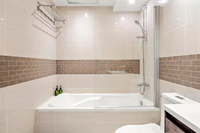 a bathroom with a bath tub and a sink at VayK - Inviting 1BR in Dubai Marina with Stunning Views in Dubai